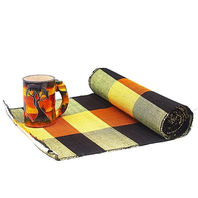 A beautifully handcrafted African Raffia Leaves set including a table runner and six placemats, showcasing intricate designs and natural textures.
